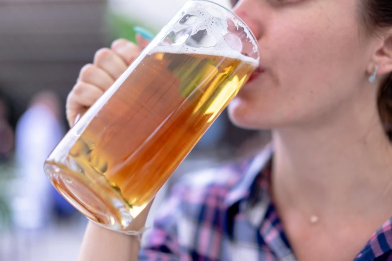 a close up of a person drinking a beer