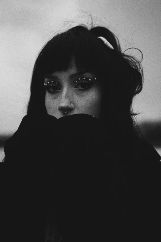 a black and white po of a woman with makeup