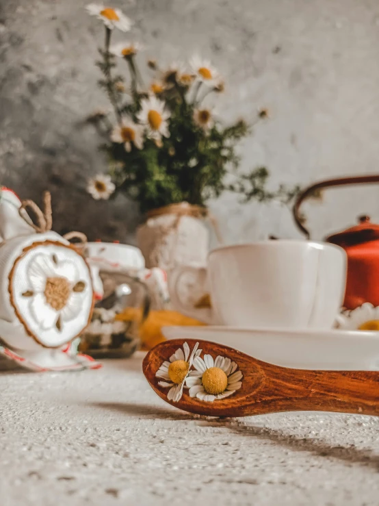 a close up of an unidentifiable tea in front of a tea kettle and bowl