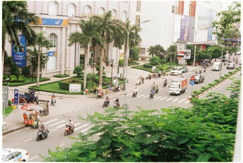 the cars and motorcycles are riding down the road