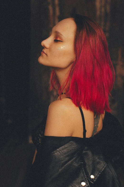 a woman with red hair and black leather dress