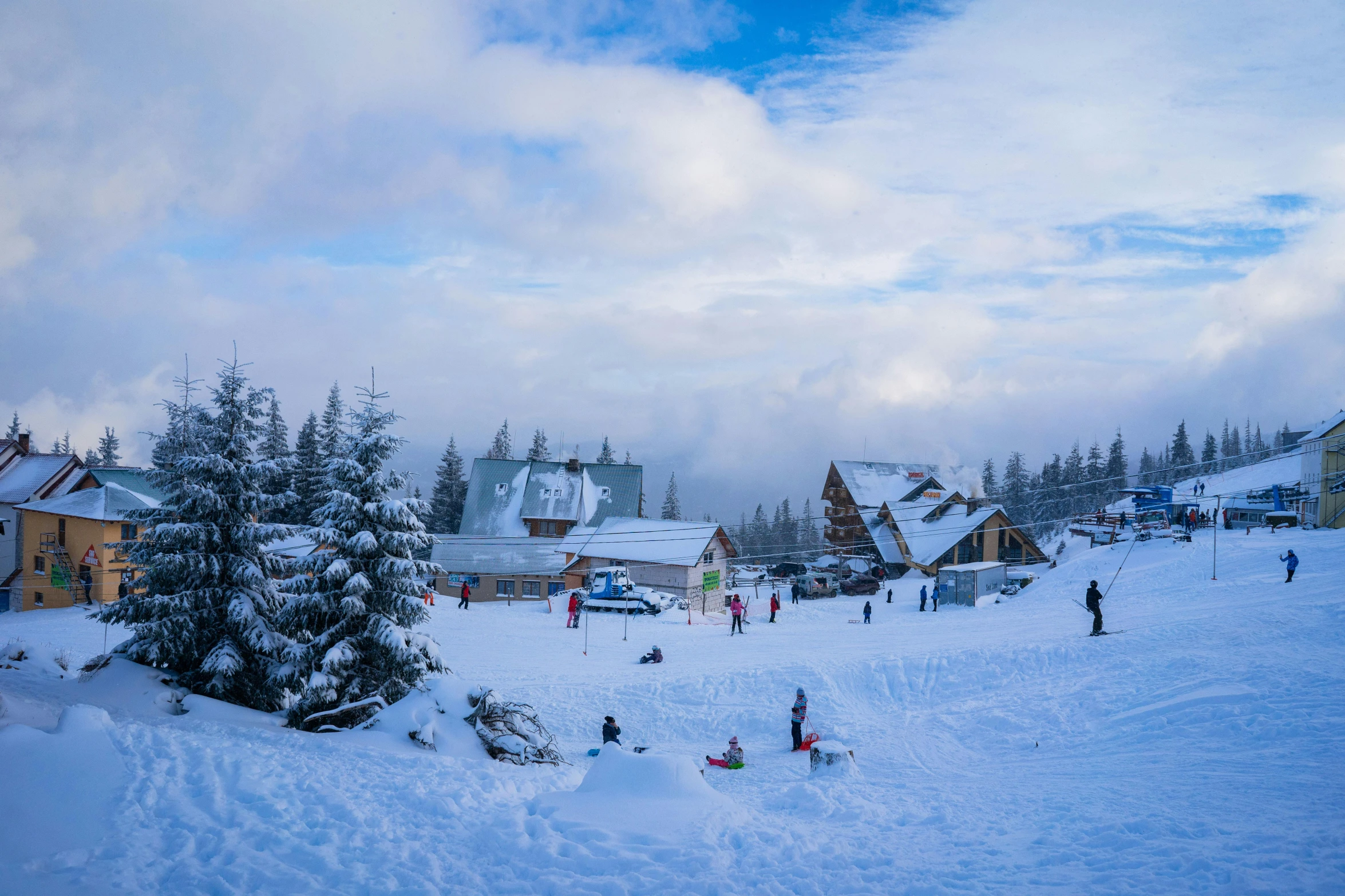 several people skiing on a ski slope in the snow