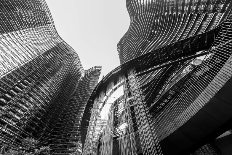 two modern buildings stand against the sky