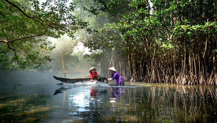 two women in a canoe paddling through the water