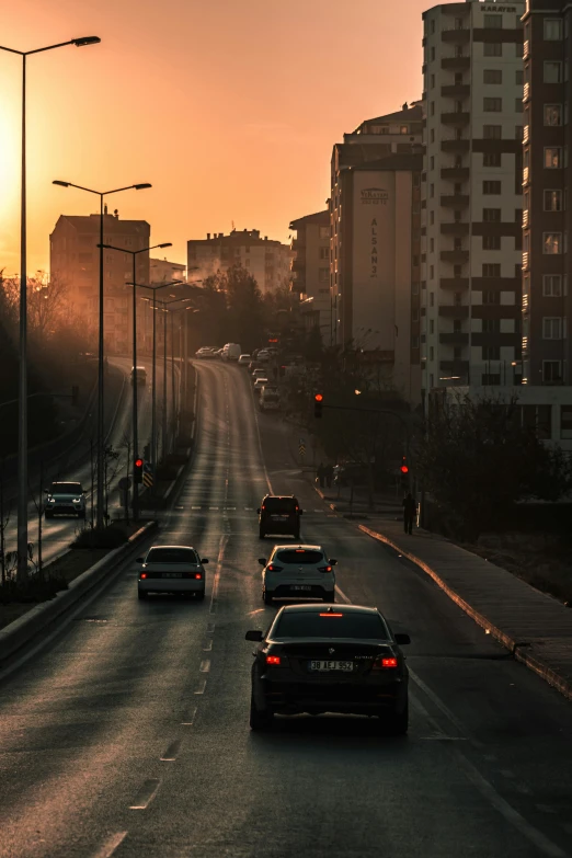 cars are driving down the road into the city