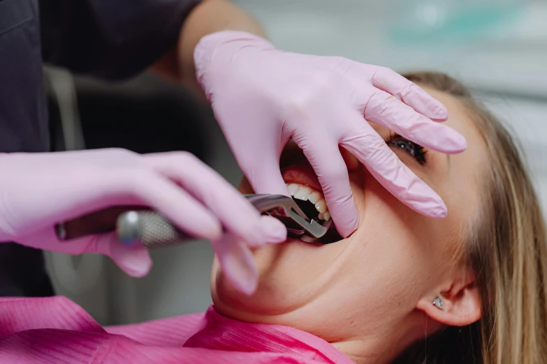 a dentist is checking on the patient's teeth