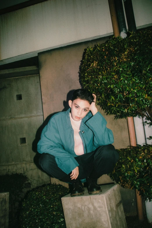 a young man in business attire sitting on a bench