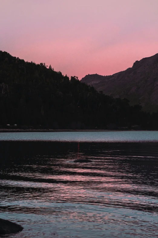 a body of water with some mountains in the background