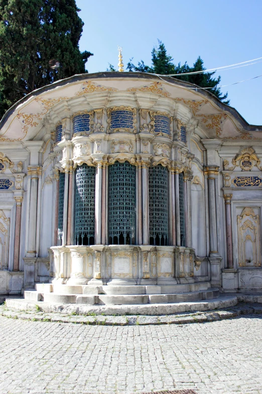 there is a white and beige building with stone steps on it