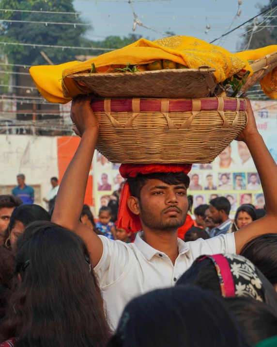 a man is carrying a basket on his head