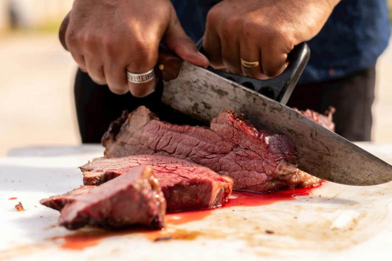 a person with scissors  steak on a table