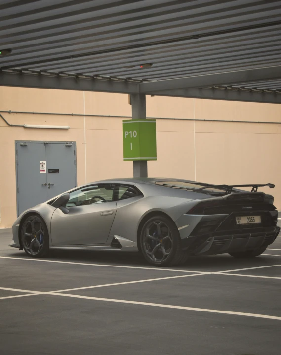 a grey lamborgr sports car in a parking lot