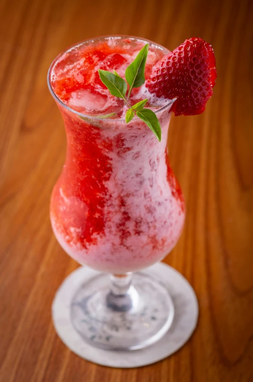 a glass filled with a strawberry and soda drink