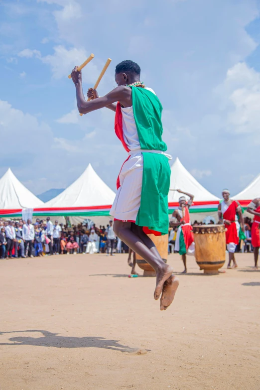 man jumping in the air with wooden stick