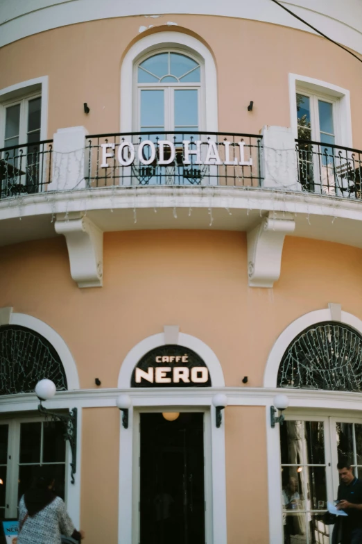 a couple of people are standing outside of a restaurant