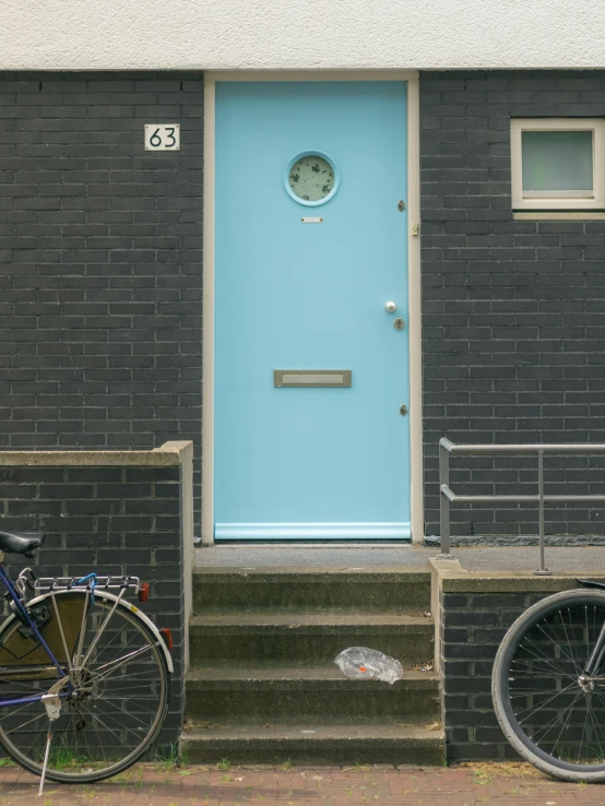there is a bicycle standing against the door of this building