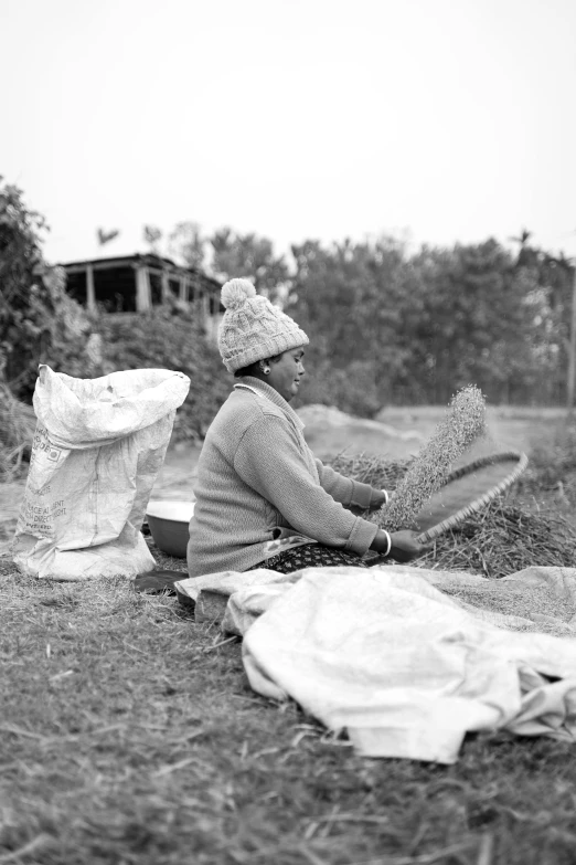 a person sitting on the ground next to bags