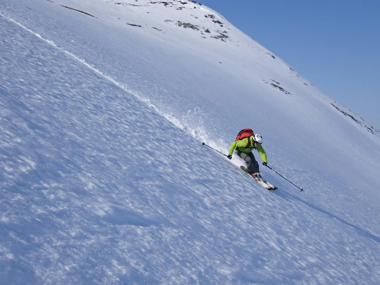 someone skiing down a snowy hill and skiing