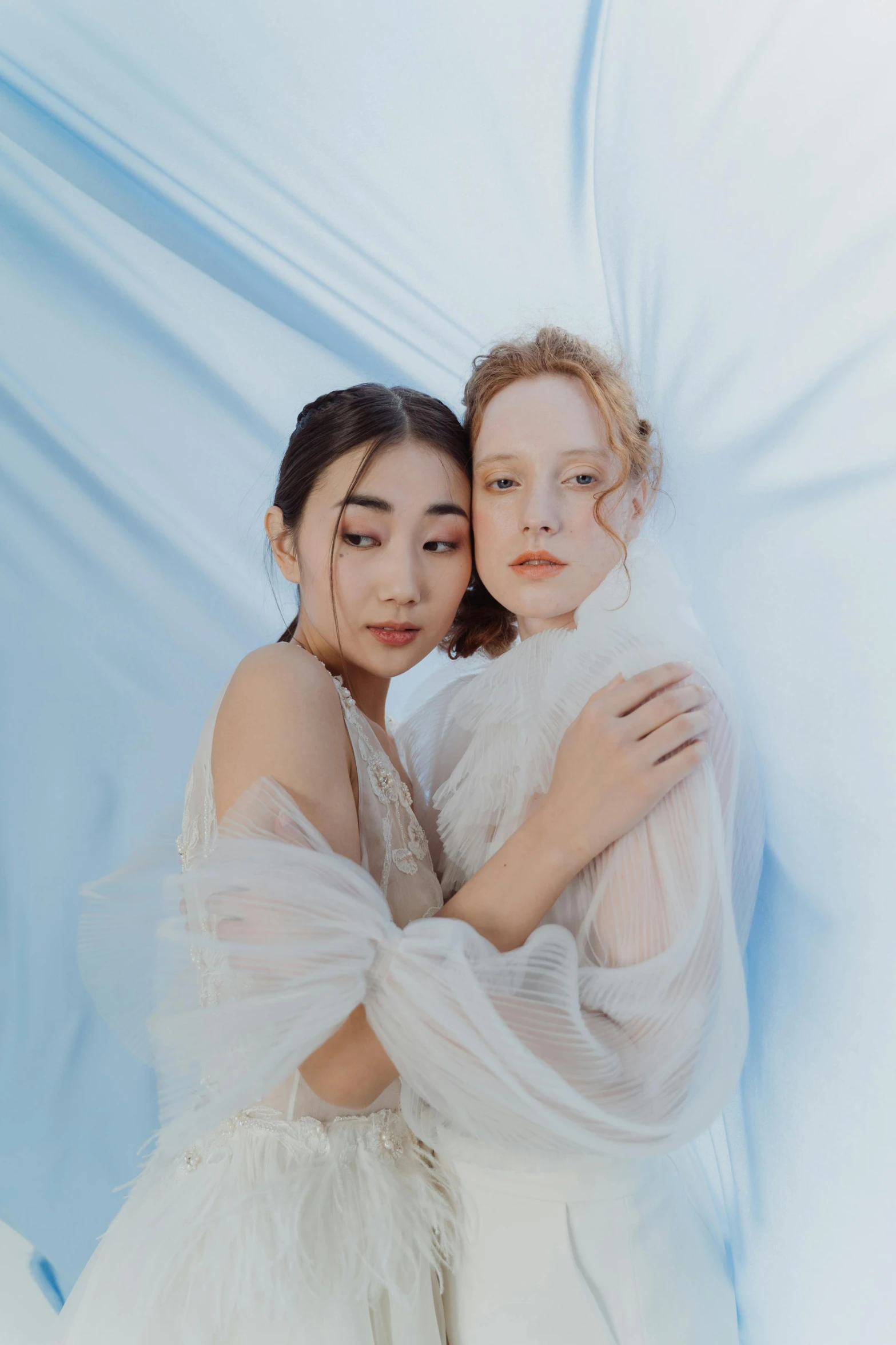 two models are hugging against an artistic background