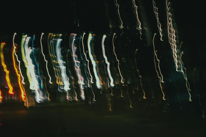 a close up view of various blurry lights on a dark background