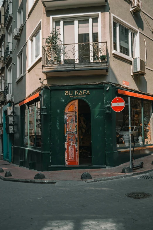 a building sitting on the corner with a bicycle parked on the street in front of it