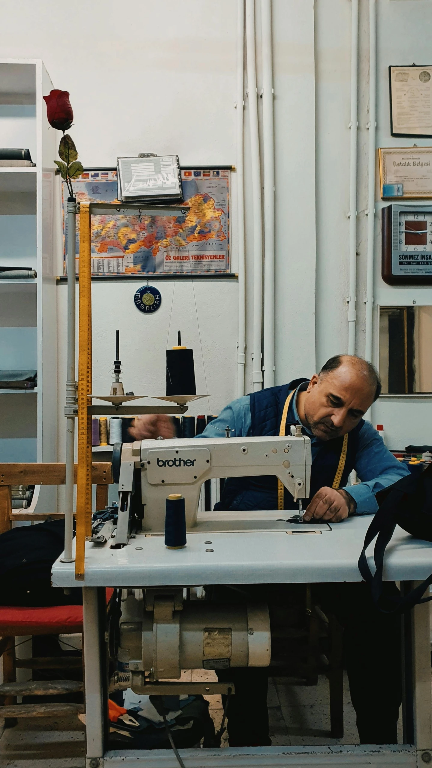 man is working on a sewing machine inside a shop