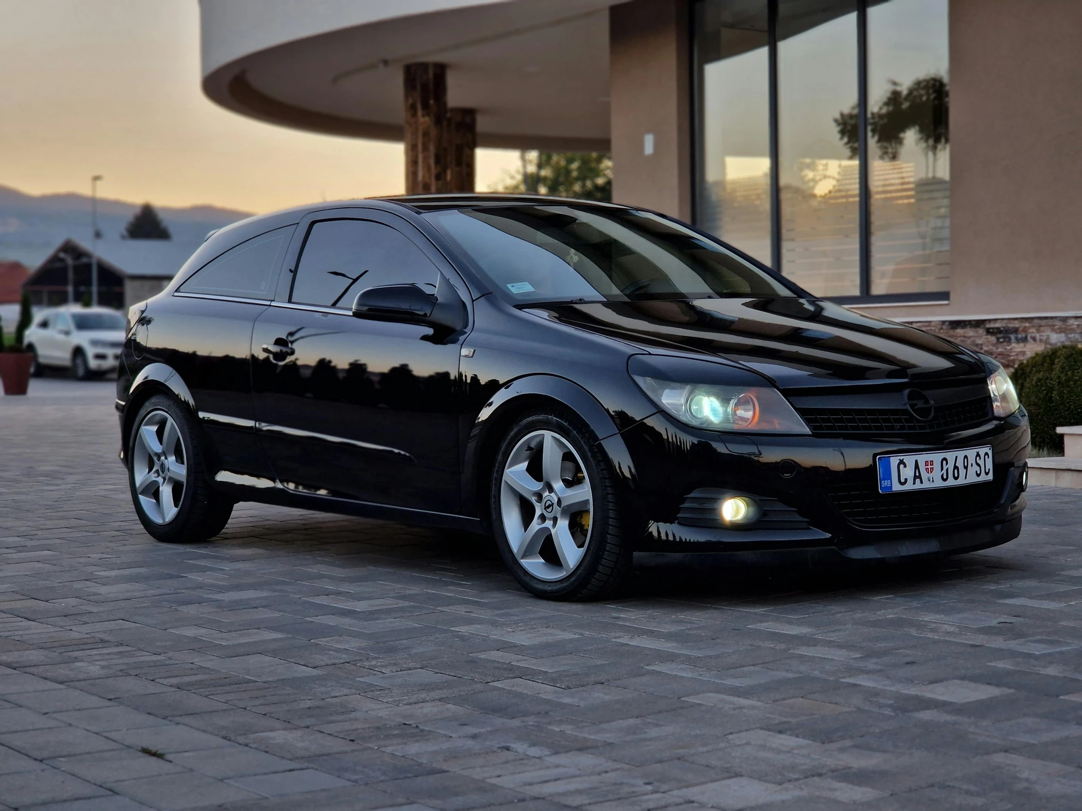 a black car parked in front of a building