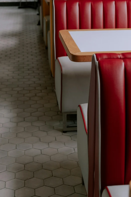 red and white booths are lined up against the wall