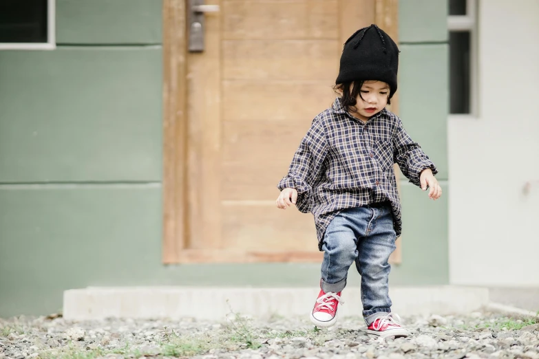 a  in red shoes walking down a path