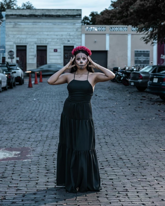 a woman in a long dress has painted white on her face