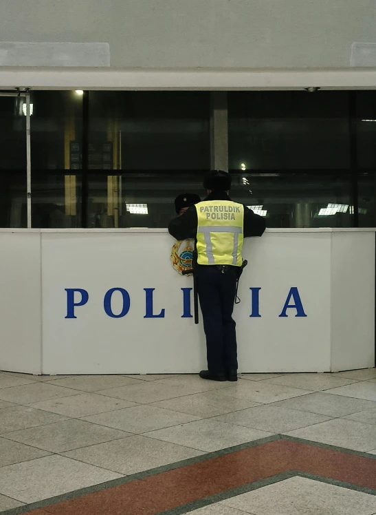 a man standing next to a white building