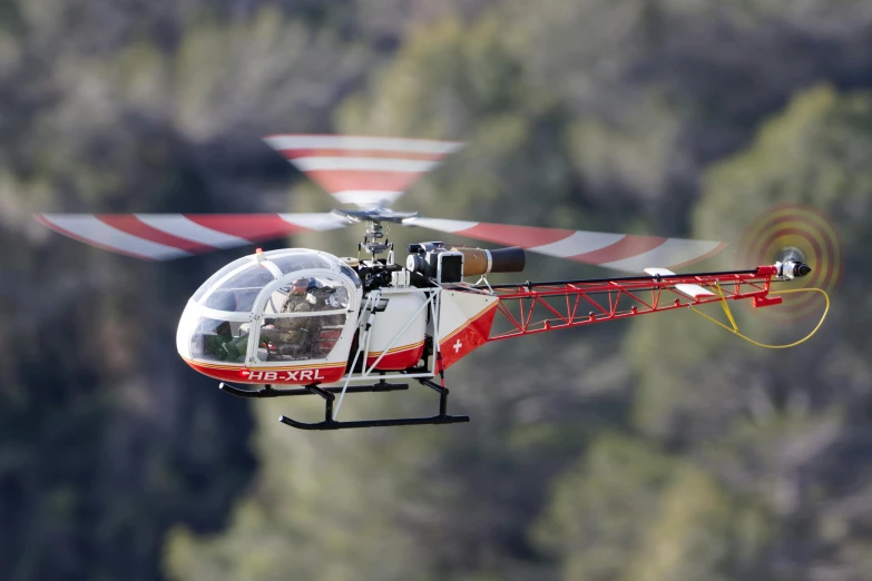 a helicopter is flying in the sky over trees