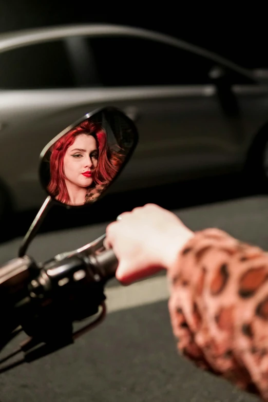 a car is reflected in the side view mirror