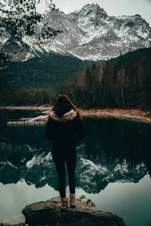 the girl is looking out at the mountains