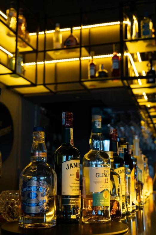 several bottles of alcohol lined up on a bar