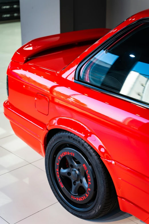 an orange sport car parked inside of a garage