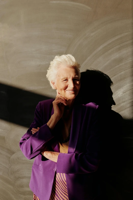 a woman poses for a picture while wearing purple