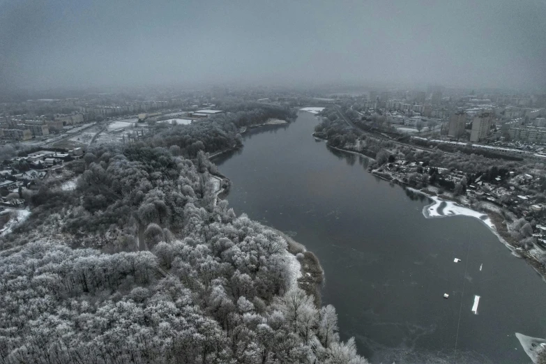 an aerial view of a frozen river in a city