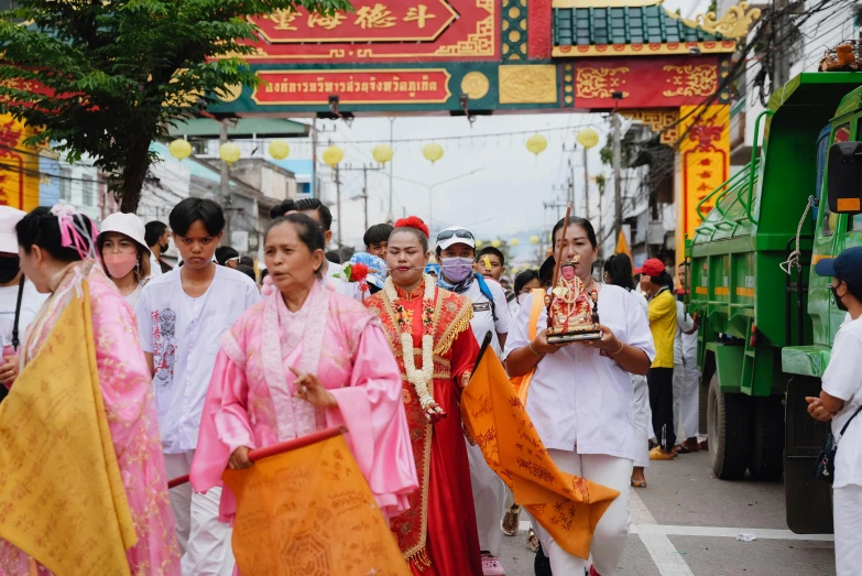 a group of people are walking through an oriental parade