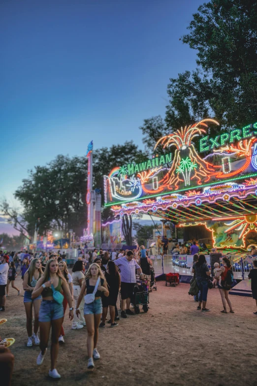 an amut park rides lit up at night with bright lights