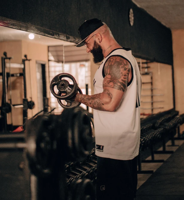 a man with tattoos is working out on some things