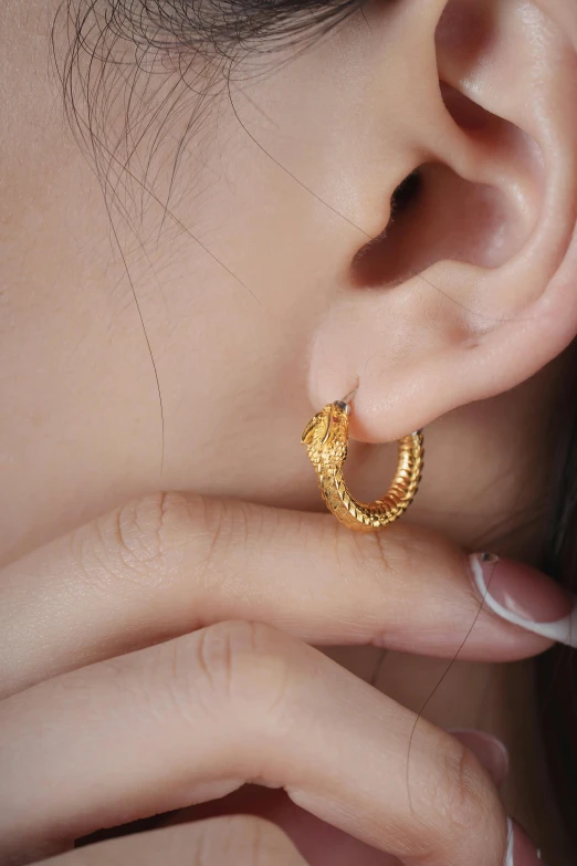 a woman wearing an elegant gold nose ring