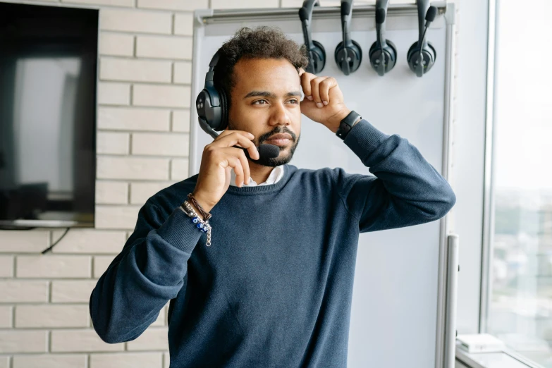 the man is listening to headphones and staring