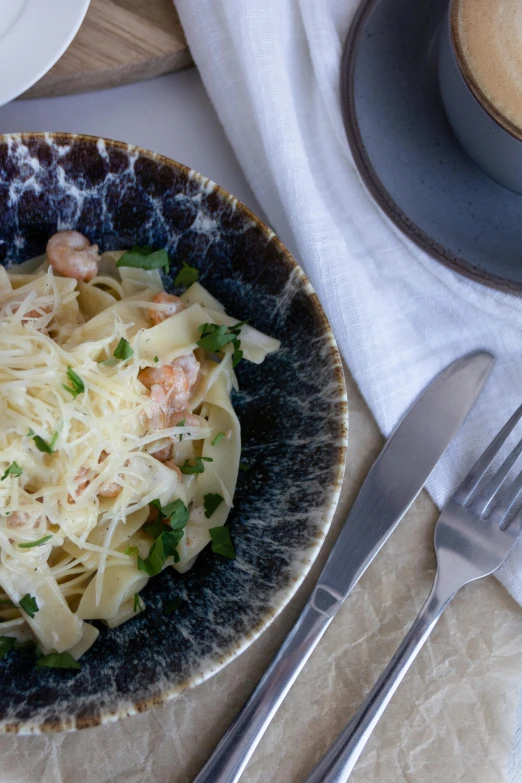 a bowl that has pasta in it on a table