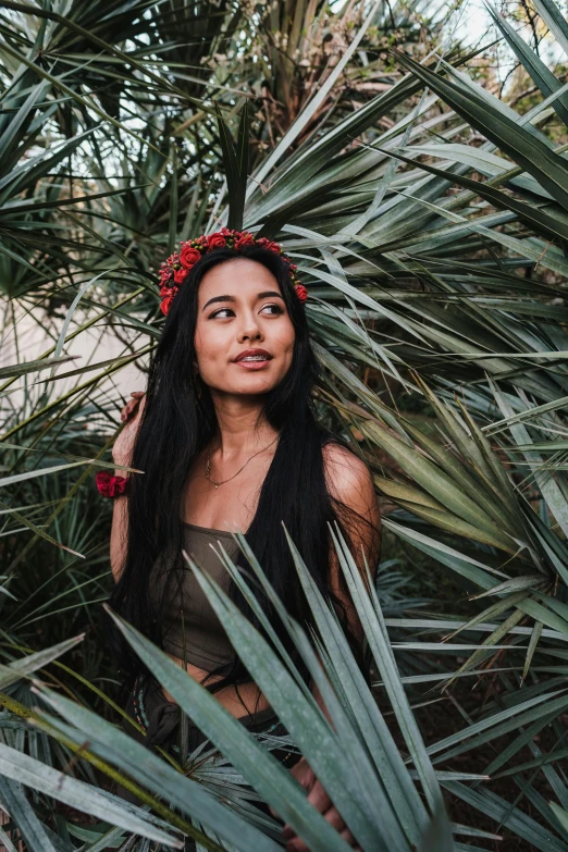 a woman posing in front of a jungle