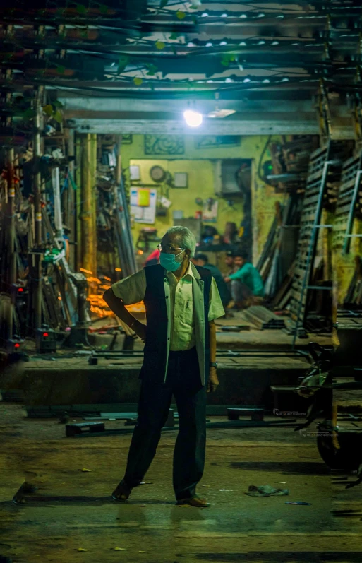 a man standing in a workshop with many types of wood