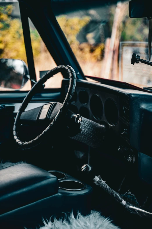 a truck dashboard is black with white fur on the floor