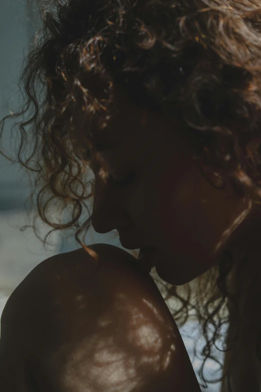 a little girl with long wavy hair in the sun