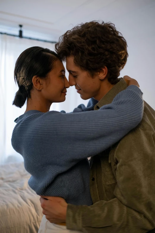 two women emcing each other in a bedroom