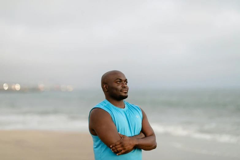 a man standing on the beach near the ocean
